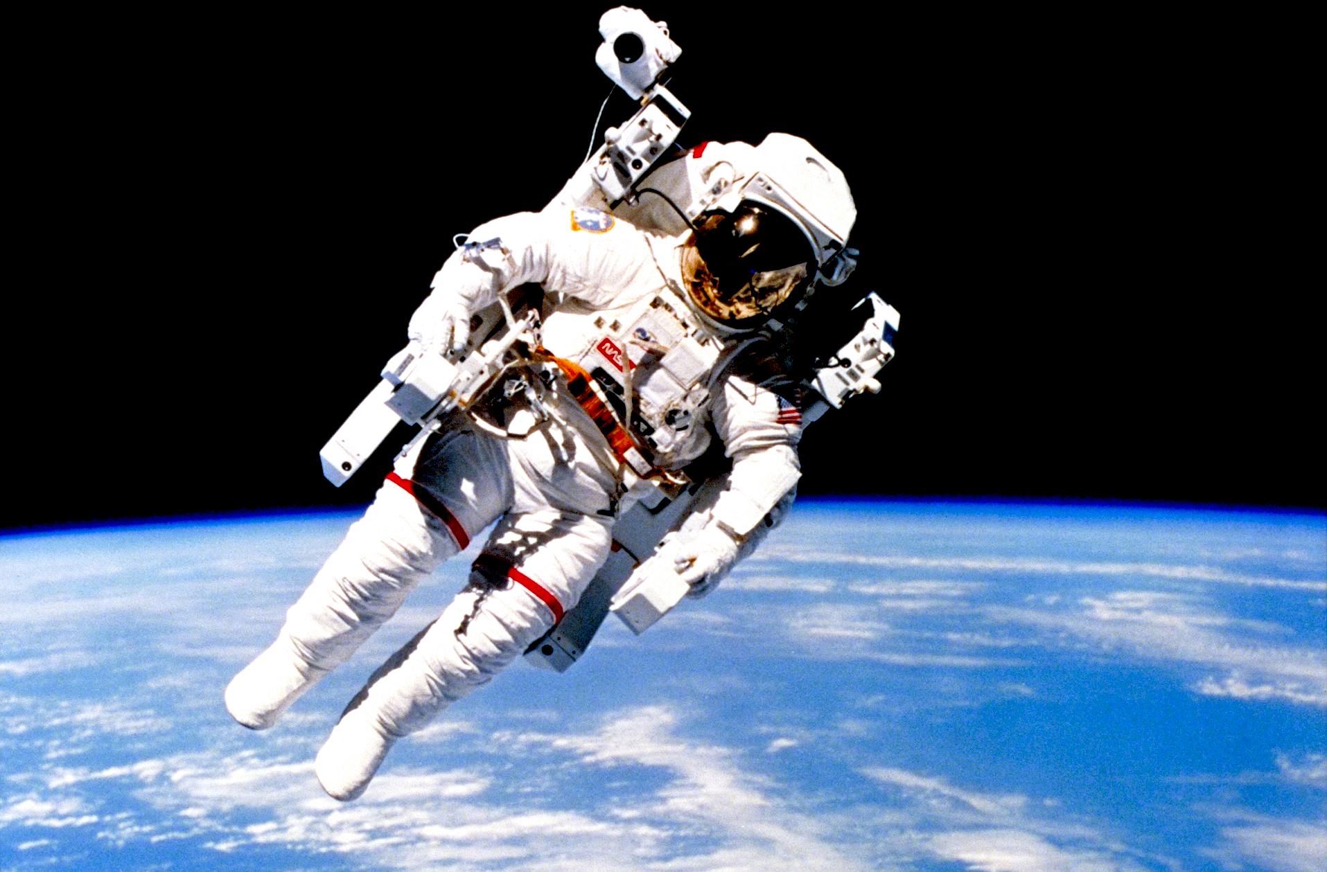 Walking in space, astronaut above planet earth